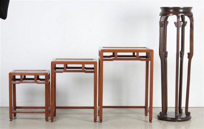 A Set of Three Chinese Wood Nesting Tables, Height: A Set of Three Chinese Wood Nesting Tables, having a rectangular top with a pierce carved frieze raised on four legs joined by stretchers, together with a hardwood stand. Height of tallest table 27 in