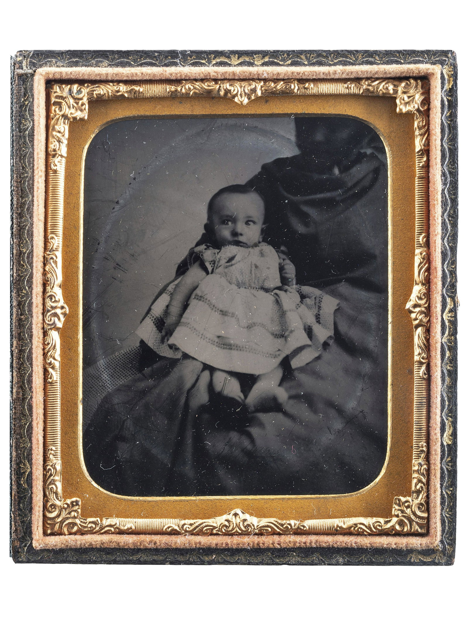 [EARLY PHOTOGRAPHY]. Sixth plate and sixteenth plate: [EARLY PHOTOGRAPHY]. Sixth plate and sixteenth plate tintypes of African American women holding white children, comprising: Sixth plate tintype of a baby wearing a dress, held in the lap of a "