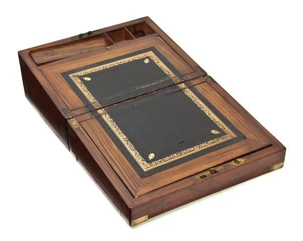 A George III Walnut Lap Desk, Height 6 x width 11 3: A George III Walnut Lap Desk, the rectangular hinged lid centered with a lobed circular shaped brass plaque, having conforming escutcheon, opening to a fitted interior with tooled leather inset writin