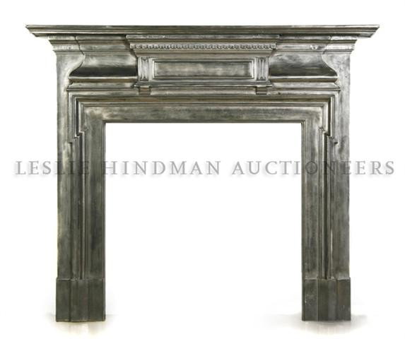 An English Cast Steel Fireplace Surround, Height 55: An English Cast Steel Fireplace Surround, of breakfront form, having a dentiled cornice over the rectangular opening. Height 55 x width 59 1/2 x depth 5 inches.