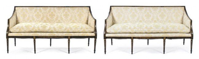A Pair of Sheraton Style Painted and Parcel Gilt S: A Pair of Sheraton Style Painted and Parcel Gilt Settees, each with upholstered backs, arms and seats within black frames, having foliate and ribbon decoration, raised on tapering legs. Height 37 x wi