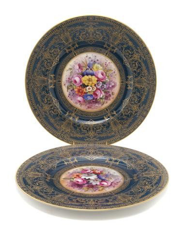 A Set of Ten Royal Worcester Bone China Service Pl: A Set of Ten Royal Worcester Bone China Service Plates, retailed by Ovington Bros. Co., New York, each with a wide blue border having gilt scrolling foliate decoration, centered with a floral still li