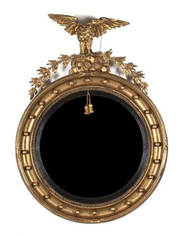 An American Federal Giltwood Bullseye Mirror, Heig: An American Federal Giltwood Bullseye Mirror, having an eagle with spread wings standing on a naturalistic base, issuing laurel branches, the mouth issuing a chain and two tassels, above the convex ci