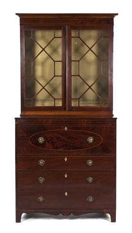 An American Mahogany Secretary Bookcase, Height 88: An American Mahogany Secretary Bookcase, in two parts, the superstructure with molded cornice over two glazed doors, the base set with a secretary drawer opening to a fitted interior over three gradua