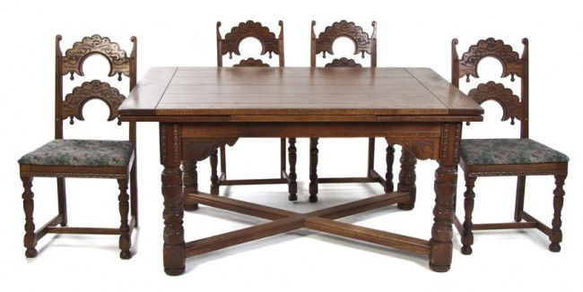 An American Oak Dining Room Suite, Height of chair: An American Oak Dining Room Suite, comprising an extension table and six chairs. Height of chairs 39 inches.