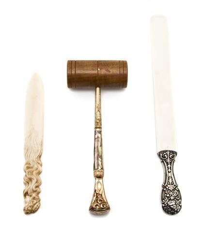 A Collection of Desk Articles, Length 15 3/4 inche: A Collection of Desk Articles, comprising a silver mounted ivory page turner, a carved Art Nouveau ivory page turner and a gavel with mother-of-pearl veneered handle. Length 15 3/4 inches.