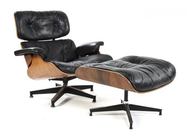 An American Lounge Chair and Ottoman, Charles and : An American Lounge Chair and Ottoman, Charles and Ray Eames, having black leather upholstery and rosewood veneered shell, the chair with Herman Miller label. Height of chair 32 inches.