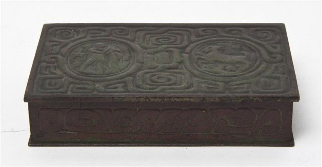 A Tiffany Studios Bronze Box, Width 5 1/4 inches.: A Tiffany Studios Bronze Box, in the Zodiac Pattern, stamped Tiffany Studios New York 810. Width 5 1/4 inches. Property from the Estate of Naomi T. Borwell, Chicago, Illinois