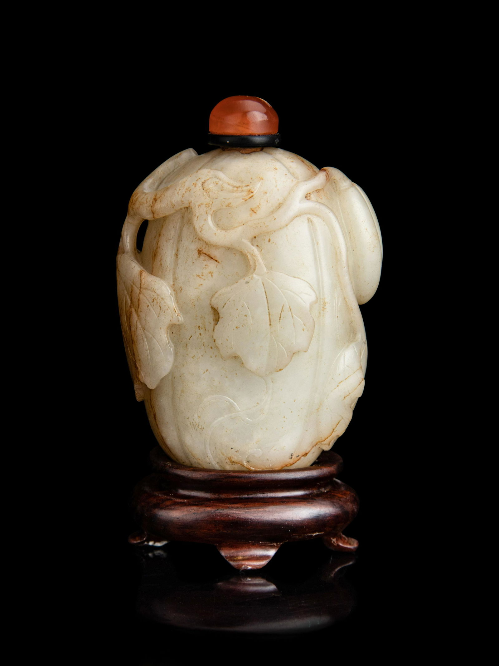A Chinese White and Russet Jade Melon-Form Snuff Bottle Height of bottle 2 1/2 in., 6.4 cm. (1 of 3)