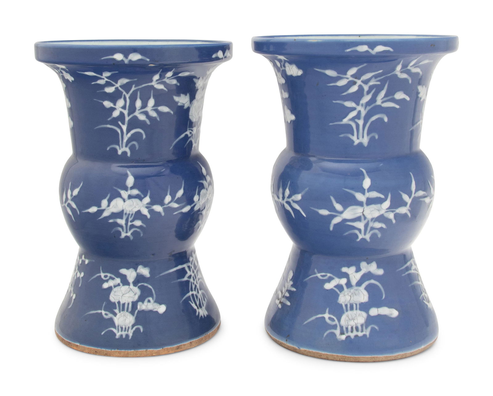 A Pair of Chinese Blue Ground White Slip Decorated Porcelain Spittoons Height 13 in., 33 cm. (1 of 4)