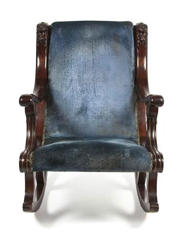 An American Empire Mahogany Rocking Chair, Height 3: An American Empire Mahogany Rocking Chair, having an upholstered back and seat, the arms with lion masks, the supports with acanthus leaf and bell flower decoration. Height 35 1/4 inches. Property fro