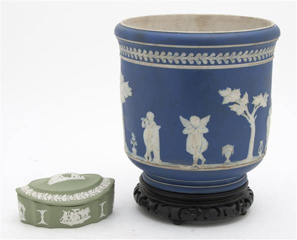 A Wedgwood Jasperware Jardiniere, Height 7 1/2 inc: A Wedgwood Jasperware Jardiniere, of circular form, with white on blue decoration, together with a covered box with white on green decoration. Height 7 1/2 inches. Property from the Estate of Dr. Wern