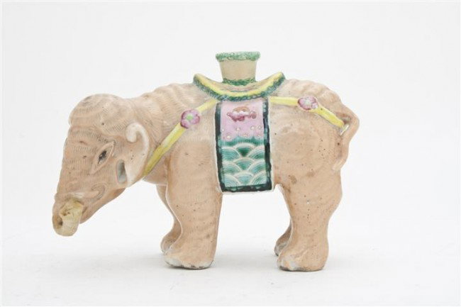 A Chinese Porcelain Elephant, Height 4 3/4 inches.: A Chinese Porcelain Elephant, having polychrome glaze throughout, shown in a standing position with a saddle blanket and an opening at top. Height 4 3/4 inches. Property from the William H. Moore Trus
