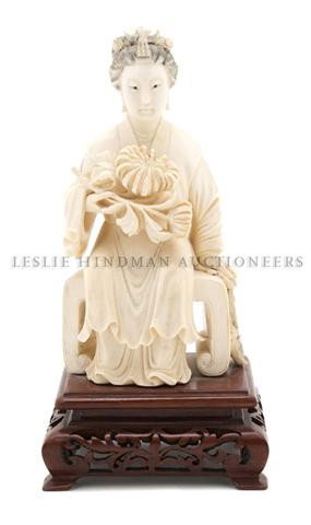 A Carved Ivory Figure of a Seated Lady, Height 7 i: A Carved Ivory Figure of a Seated Lady, the figure atop a bench, with a flowering chrysanthemum cradled in her arm. Height 7 inches. Property from a Chicago Collection