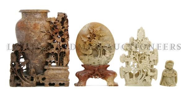 A Group of Three Chinese Soapstone Carvings, Heigh: A Group of Three Chinese Soapstone Carvings, comprising one vase of russet colored stone with foliate decoration, the second of olive colored stone depicting flowering plants and rocks and the third o