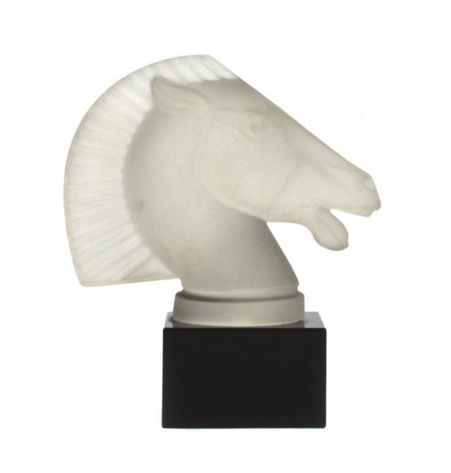 A Rene Lalique Glass Radiator Cap, Height 7 inches.: A Rene Lalique Glass Radiator Cap, Longchamp, depicting the head of a Grecian horse, raised on a black glass base. Height 7 inches.