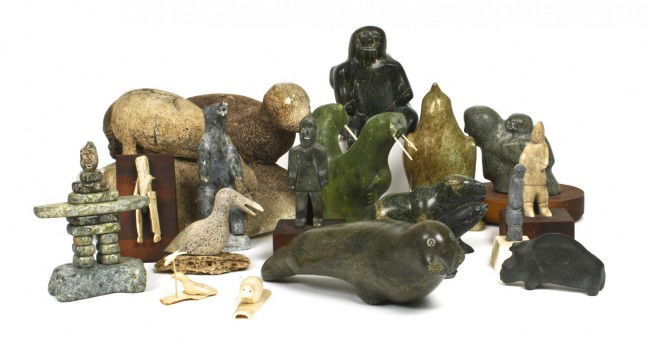 A Collection of Eighteen Inuit Carvings, Height of tall: A Collection of Eighteen Inuit Carvings, of animal and human form, comprising articles in stone, walrus ivory, and whale bone. Height of tallest 7 1/4 inches.