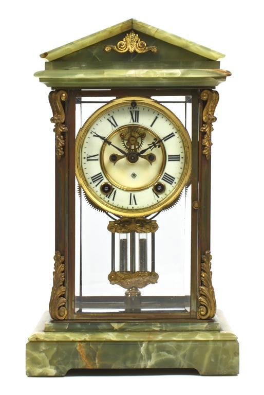 An American Green Onyx Mantel Clock, Ansonia, Height 13: An American Green Onyx Mantel Clock, Ansonia, of temple form, the sides with gilt metal foliate mounts, the sunken dial with Roman numerals, having mercury filled pendulum, raised on bracket feet. Hei