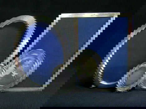 4 sterling silver photo frames, early 20th centur: 4 sterling silver photo frames early 20th century One rectangular with 13 x 9 1/4 in. opening, 3 oval, one with 11 3/4 x 8 in. opening with ball feet, and 2 graduated matching easel frames with floral