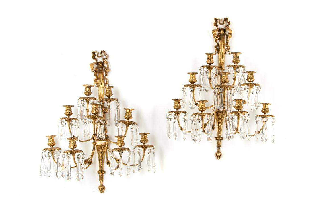 A Pair of Louis XVI Style Gilt Bronze and Cut Glass Nine-Light Sconces: A Pair of Louis XVI Style Gilt Bronze and Cut Glass Nine-Light Sconces Late 19th/Early 20th Century each impressed 14 to the reverse; not wired for electricity. Height 28 x width 19 inches.