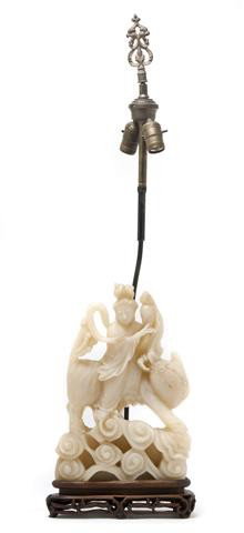 A Chinese Carved Soapstone Figural Group, Height o: A Chinese Carved Soapstone Figural Group, depicting Guanyin atop a striding kylin, set on a wood base and mounted as a lamp. Height overall 35 3/4 inches.