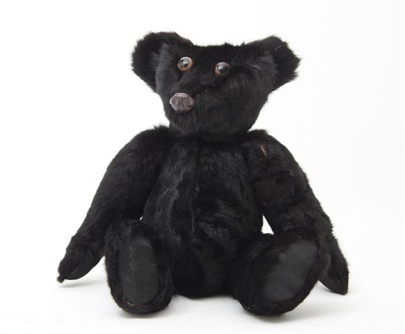 A Vintage Fur Teddy Bear, Height overall 15 inches: A Vintage Fur Teddy Bear, having a black mink body, brown eyes and a leather nose. Height overall 15 inches.