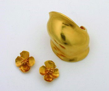 Group of Robert Lee Morris Jewelry: Group of Robert Lee Morris Jewelry 1990Comprising a gold cuff bracelet, and a pair of gold floral clip earrings. Polished gold plating.Excellent condition.