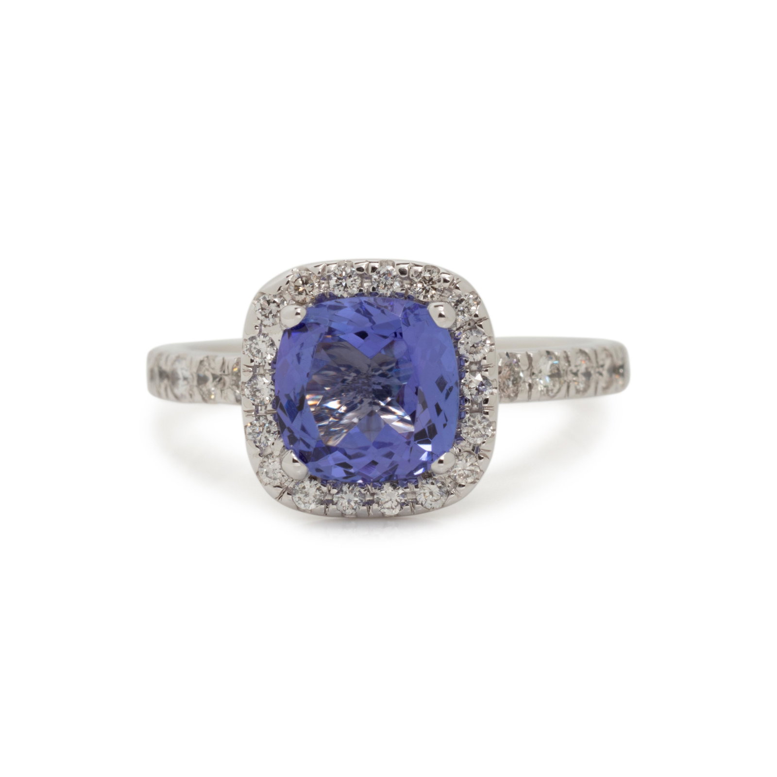 TANZANITE AND DIAMOND RING: TANZANITE AND DIAMOND RING Containing one cushion mixed cut tanzanite measuring approximately 7.75 x 7.60 mm and 36 round brilliant cut diamonds weighing approximately 0.50 carat total. Mounted in whi