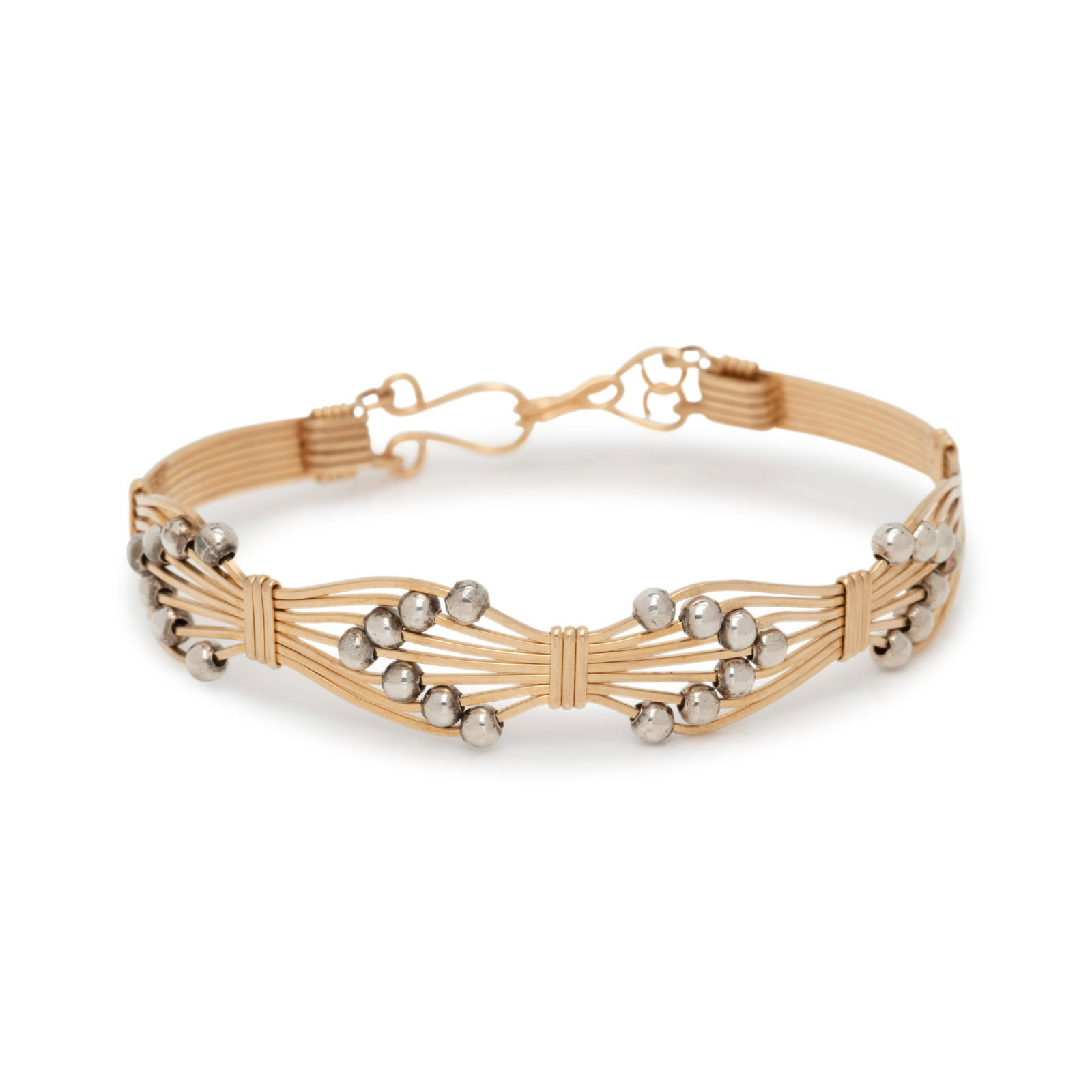 YELLOW GOLD AND SILVER BRACELET: YELLOW GOLD AND SILVER BRACELET Consisting of gold wire with round silver beads. 6 3/8 inches inner circumference. Gross weight: 4.85 dwt. Property of an Old Society Lady, Denver, Colorado