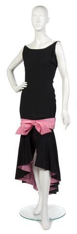 An Estevez Black Silk Evening Gown with Pink Bow an: An Estevez Black Silk Evening Gown with Pink Bow and Cut-away Pink Skirt. Labeled: Estevez. Property from the Collection of Gladys Knight, Las Vegas, Nevada
