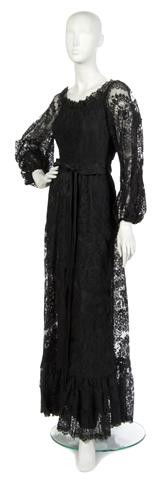 A Bill Blass Black Lace Evening Gown,: A Bill Blass Black Lace Evening Gown, early 1970s, with an off-the-shoulder neckline, black satin belt at waist, ruffle hemline. Labeled: Bill Blass.