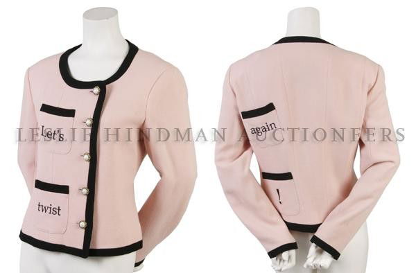 A Moschino 'Let's Twist Again' Wool Crépe Jacket,: A Moschino 'Let's Twist Again' Wool Crépe Jacket, pink with black trim, asymmetrical closure, faux pearl buttons, and embroidered to read 'Let's twist again!' Fully lined. Labeled: Cheap and Chic/Mos