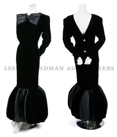 A Givenchy Black Silk Evening Dress,: A Givenchy Black Silk Evening Dress, 1989, in velvet with satin trim, jewel neckline with oversized bow, crystal buttons, shaped bubble hem, fully lined. Labeled: Givenchy/Nouvelle Boutique.