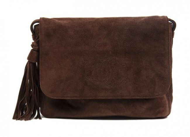 A Chanel Brown Suede Bag, 11 x 8 inches.: A Chanel Brown Suede Bag, with long shoulder strap, logo flap closure with tassel. Stamped: Chanel. 11 x 8 inches.