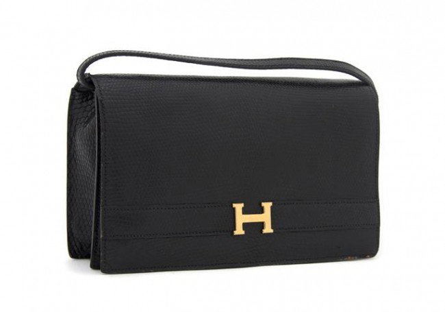 An Hermes Black Lizard Annie Pouchette, 24 x 15 cm: An Hermes Black Lizard Annie Pouchette, with a gold H at front, detachable matching strap. Stamped: Hermes/Paris. 24 x 15 cm (9 1/2 x 6 inches).