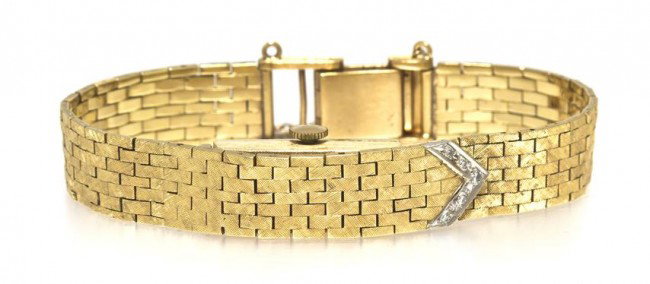 A 14 Karat Yellow Gold Wristwatch, Piagale, 21.35 : A 14 Karat Yellow Gold Wristwatch, Piagale, brick link bracelet with Florentine finish, hidden dial with white gold chevron accent containing five round single cut diamonds weighing approximately 0.05