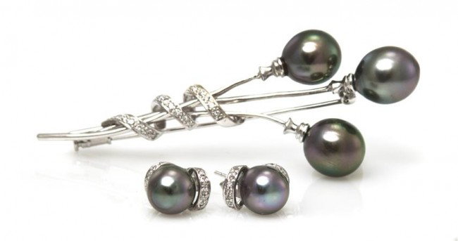 A Set of 18 Karat White Gold, Cultured Tahitian Pe: A Set of 18 Karat White Gold, Cultured Tahitian Pearl and Diamond Jewelry, consisting of a brooch containing three oval pearls measuring approximately 10.00 - 10.40 mm in diameter and 22 round brillia