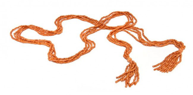 A Four Strand Coral Bead Necklace,: A Four Strand Coral Bead Necklace, containing beads measuring approximately 3.30 - 8.30 mm in diameter strung in four strands with two tassel terminations. Length 51 inches.