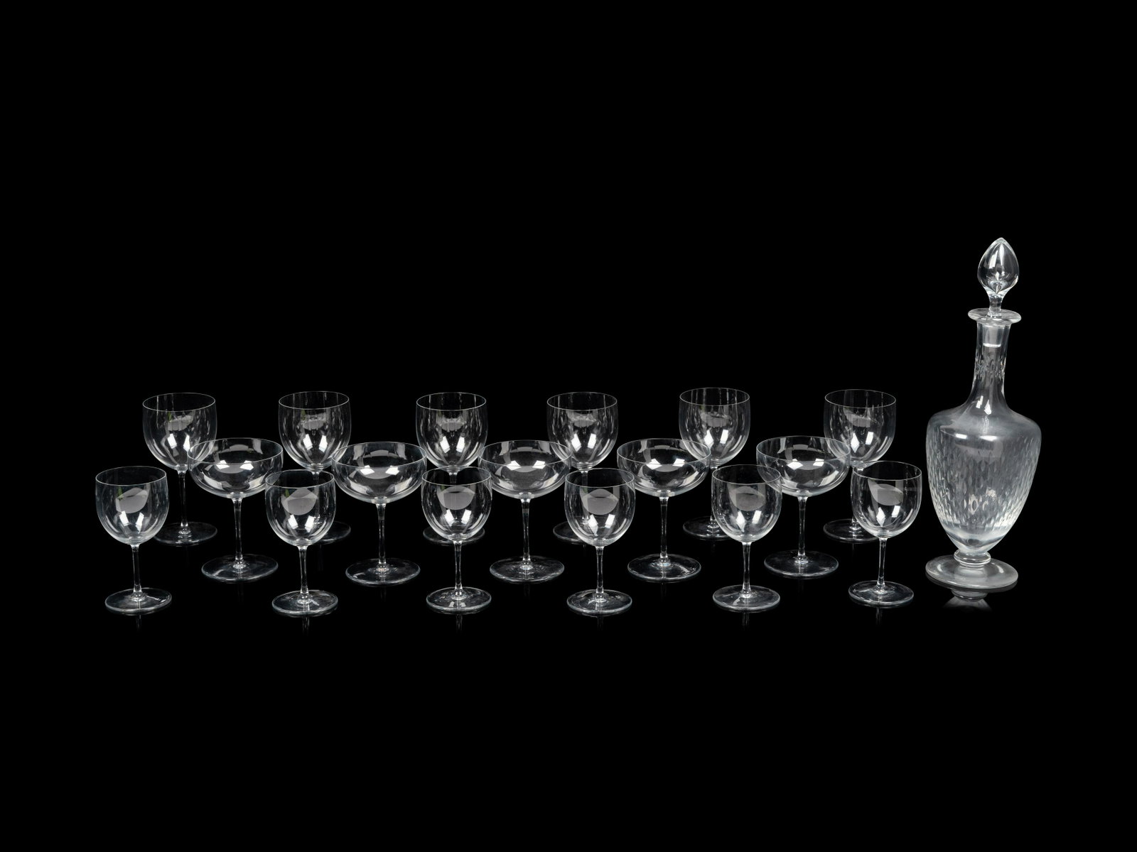 A Baccarat Stemware Service Height of wine glasses 5 3/4 inches.: A Baccarat Stemware Service 20th Century comprising eleven wine glasses, six dessert wine glasses, eight coupe glasses and a decanter; 26 items total. Height of wine glasses 5 3/4 inches. Property of 