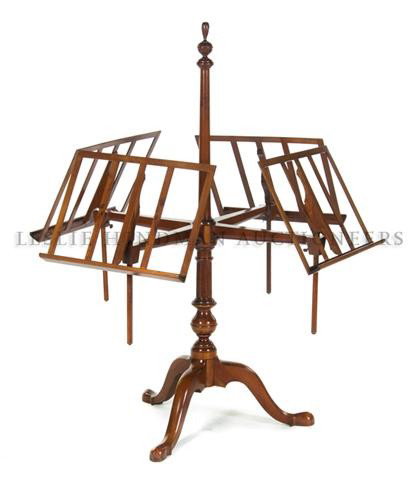 A Georgian Style Mahogany Quartet Music Stand, Heig: A Georgian Style Mahogany Quartet Music Stand, having a flaming urn finial over the four adjustable sheet music holders, raised on a tripod base. Height 55 inches.