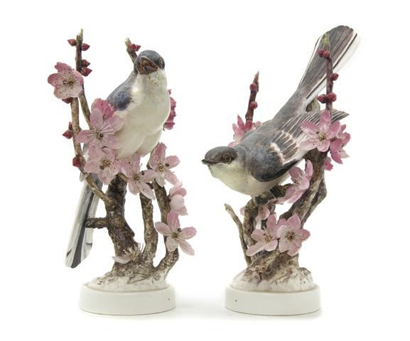 A Pair of Royal Worcester Dorothy Doughty Birds, M: A Pair of Royal Worcester Dorothy Doughty Birds, Mocking Birds, seated on peach blossom branches. Height of taller 10 15/16 inches.