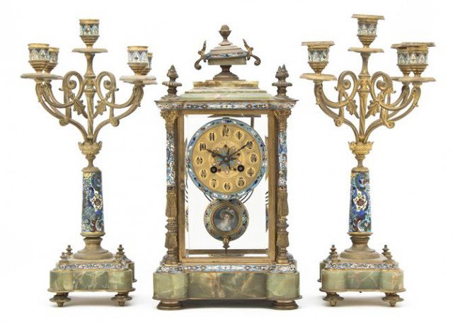 A French Bronze, Champleve and Onyx Three-Piece Cl: A French Bronze, Champleve and Onyx Three-Piece Clock Garniture, Leroy, comprising a clock and two five-light candelabra, each with conforming stylized foliate enameling, the clock with time and strik