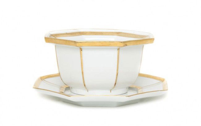 A Meissen Porcelain Bowl and Saucer, Diameter of l: A Meissen Porcelain Bowl and Saucer, of octagonal form with gilt decoration, having crossed sowrds mark in underglaze blue. Diameter of larger 6 3/4 inches.