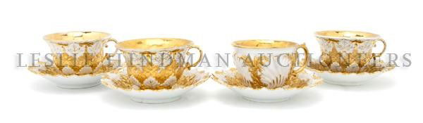A Set of Three Meissen Porcelain Cups and Saucers,: A Set of Three Meissen Porcelain Cups and Saucers, each with gilt grape leaf decoration, together with an associated cup, each with crossed swords mark in underglaze blue. Height of cups 2 1/2 inches.