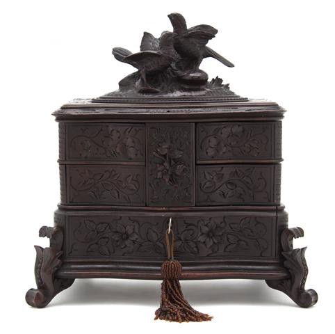 A Black Forest Carved Wood Table Casket, Height 10: A Black Forest Carved Wood Table Casket, the hinged rectangular top with carved bird decoration opening to four swing out compartments, raised on scrolling feet. Height 10 1/2 inches.