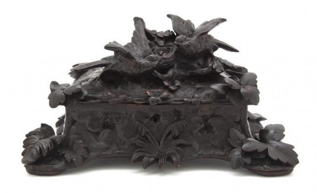 A Black Forest Carved Wood Table Casket, Width 12: A Black Forest Carved Wood Table Casket, the rectangular lift top carved with two birds by a nest, raised on leafy feet. Width 12 1/4 inches.
