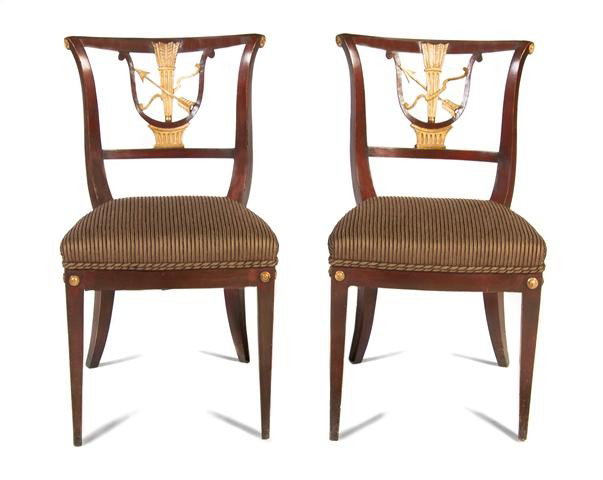 A Pair of Continental Neoclassical Side Chairs, He: A Pair of Continental Neoclassical Side Chairs, 19th century, having bow, arrow and quiver splat over the upholstered seat raised on saber legs. Height 33 1/2 inches.