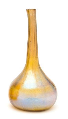 A Tiffany Studios Favrile Glass Bud Vase, Height 5: A Tiffany Studios Favrile Glass Bud Vase, of bottle form, signed L.C.T. W7062, likely adapted from a larger vase. Height 5 7/8 inches. Property from the Estate of John Haight, Arlington Heights, Illin
