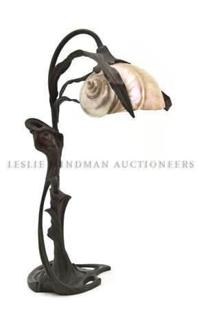 An Austrian Art Nouveau Figural Lamp, Height 16 5/: An Austrian Art Nouveau Figural Lamp, having a nautilus shell shade, raised on a foliate and maiden form base. Height 16 5/8 inches.