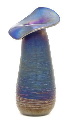 An Austrian Iridescent Glass Vase, in the manner o: An Austrian Iridescent Glass Vase, in the manner of Loetz, of jack-in-the-pulpit form, with applied string decoration on a cobalt ground. Height 8 5/8 inches. Property from the Estate of John Haight,